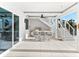 A covered outdoor kitchen and dining area features a built-in grill, bar seating, and staircase at 32 Gulf Blvd, Indian Rocks Beach, FL 33785