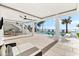 Spacious outdoor living area with kitchen, lounge, and pool access, perfect for entertaining at 32 Gulf Blvd, Indian Rocks Beach, FL 33785