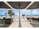 A covered patio features stylish furniture and beautiful beach views in this stunning home at 32 Gulf Blvd, Indian Rocks Beach, FL 33785