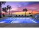 Beautiful pool area with ocean views, lounge chairs and vibrant sunset sky at 32 Gulf Blvd, Indian Rocks Beach, FL 33785