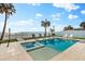 Amazing backyard pool featuring a spa, lounge chairs, and beautiful beach scenery at 32 Gulf Blvd, Indian Rocks Beach, FL 33785
