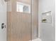 Elegant shower with textured tile, glass door, and built-in niche at 32 Gulf Blvd, Indian Rocks Beach, FL 33785