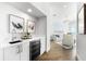 Elegant wet bar with sleek countertops, under-counter refrigerator, and modern fixtures at 32 Gulf Blvd, Indian Rocks Beach, FL 33785