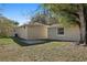 Exterior shot of the backyard with green grass, a patio, and a home at 3220 10Th N St, St Petersburg, FL 33704