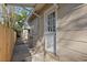 A backyard view showing an exterior white door with glass panes, and a fenced in yard at 3220 10Th N St, St Petersburg, FL 33704
