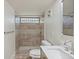 Bathroom with shower and decorative tile work around the shower and flooring at 3220 10Th N St, St Petersburg, FL 33704