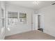 Bright bedroom featuring neutral carpet, white walls, and a window bringing in natural light at 3220 10Th N St, St Petersburg, FL 33704