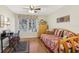 Bright bedroom with a daybed, a spacious window, and a functional desk area, offering a versatile space at 3310 Haviland Ct # 202, Palm Harbor, FL 34684