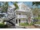 Condo exterior showcasing multiple levels, stairs, and well-maintained landscaping near a body of water at 3310 Haviland Ct # 202, Palm Harbor, FL 34684