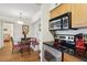 Stylish kitchen with stainless steel appliances, adjacent to the dining area with built-in seating at 3310 Haviland Ct # 202, Palm Harbor, FL 34684