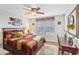 Comfortable bedroom with a ceiling fan, a cozy bed, and natural light, creating a relaxing atmosphere at 3310 Haviland Ct # 202, Palm Harbor, FL 34684