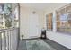 Charming porch featuring wood-like floors and walls, with an exterior door and windows letting in the sunlight at 3310 Haviland Ct # 202, Palm Harbor, FL 34684