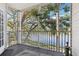 Relaxing screened porch with views of the lake, lush greenery and trees, and providing an outdoor living space at 3310 Haviland Ct # 202, Palm Harbor, FL 34684