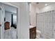 Well-lit bathroom with a vanity sink and a shower/tub with a patterned curtain and neutral colors at 33298 Major Oak Dr, Wesley Chapel, FL 33545