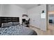 Comfortable bedroom with a large bed, a desk, and ample closet space for storage at 33298 Major Oak Dr, Wesley Chapel, FL 33545