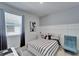 Well-lit bedroom with light-colored walls and flooring, complemented by neutral furnishings at 33298 Major Oak Dr, Wesley Chapel, FL 33545