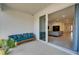 Covered patio with comfortable seating, offering a view into the home's open living space at 33298 Major Oak Dr, Wesley Chapel, FL 33545