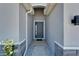 Inviting entryway features a stylish front door and modern architectural details at 33298 Major Oak Dr, Wesley Chapel, FL 33545