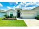 Charming single-story home with well-maintained lawn and manicured landscaping, enhancing its curb appeal at 33298 Major Oak Dr, Wesley Chapel, FL 33545