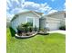 Charming one-story home featuring manicured landscaping, a two-car garage, and a well-maintained lawn at 33298 Major Oak Dr, Wesley Chapel, FL 33545