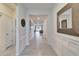 Long hallway featuring ceramic flooring and molding details with access to the living room at the end at 33298 Major Oak Dr, Wesley Chapel, FL 33545