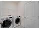 Bright laundry room equipped with a modern washer and dryer for efficient laundry care at 33298 Major Oak Dr, Wesley Chapel, FL 33545