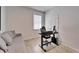 Bright office space featuring a gray sofa and work area, perfect for productivity at 33298 Major Oak Dr, Wesley Chapel, FL 33545