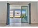 View of covered patio with ample outdoor space, accessed through sliding glass doors at 33298 Major Oak Dr, Wesley Chapel, FL 33545