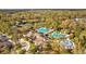 An aerial view of community clubhouse, pools, tennis courts, and recreational areas at 3543 Watermark Dr, Wesley Chapel, FL 33544