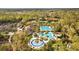Overhead shot of neighborhood recreational facilities, featuring pools, tennis courts, and lush landscaping at 3543 Watermark Dr, Wesley Chapel, FL 33544