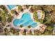Overhead shot featuring community pool with lounge seating, landscaped surroundings and inviting atmosphere at 3543 Watermark Dr, Wesley Chapel, FL 33544