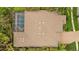 Aerial view of a private pool with a screened enclosure on a large lot surrounded by lush landscaping at 3543 Watermark Dr, Wesley Chapel, FL 33544