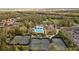 Aerial view of community amenities featuring swimming pool, tennis courts, landscaping and community center at 3543 Watermark Dr, Wesley Chapel, FL 33544