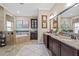 Bathroom featuring walk in shower, soaking tub, double vanity and custom tile work at 3543 Watermark Dr, Wesley Chapel, FL 33544