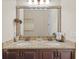Well-lit bathroom with a double vanity, granite countertops, and modern fixtures at 3543 Watermark Dr, Wesley Chapel, FL 33544