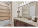 Elegant bathroom with a double vanity, granite countertop, and decorative tile accents at 3543 Watermark Dr, Wesley Chapel, FL 33544