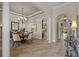 Elegant dining room featuring a chandelier, arched doorway, and tiled flooring at 3543 Watermark Dr, Wesley Chapel, FL 33544