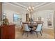 Elegant dining room featuring a round table with seating for six and a decorative chandelier at 3543 Watermark Dr, Wesley Chapel, FL 33544