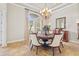 Inviting dining room bathed in natural light, featuring elegant chairs and tiled flooring at 3543 Watermark Dr, Wesley Chapel, FL 33544