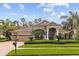 Beautiful home exterior showcasing a manicured lawn, mature trees, and a three-car garage at 3543 Watermark Dr, Wesley Chapel, FL 33544