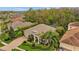 Aerial view of a beautiful home with lush landscaping, a screened-in pool, and a brick-paved driveway at 3543 Watermark Dr, Wesley Chapel, FL 33544