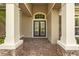 Welcoming front entrance with elegant double doors and stone accents under a covered porch at 3543 Watermark Dr, Wesley Chapel, FL 33544