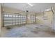 Spacious three-car garage featuring two garage doors, overhead lighting, and ample storage space at 3543 Watermark Dr, Wesley Chapel, FL 33544