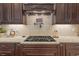 Close up of a kitchen featuring a gas range, granite countertops and tile backsplash at 3543 Watermark Dr, Wesley Chapel, FL 33544