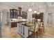 Spacious kitchen with dark wood cabinets, island with seating, and tile flooring at 3543 Watermark Dr, Wesley Chapel, FL 33544