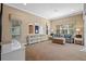 Spacious living room featuring large windows, a comfortable sofa, a storage unit, and neutral walls and carpet at 3543 Watermark Dr, Wesley Chapel, FL 33544