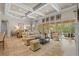Spacious living room with coffered ceiling, large windows, comfortable seating, and stylish decor at 3543 Watermark Dr, Wesley Chapel, FL 33544