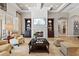 Cozy living room featuring a fireplace, built-in shelving, comfortable seating, and elegant decor at 3543 Watermark Dr, Wesley Chapel, FL 33544