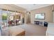 Open living room leading to a covered lanai with outdoor seating, a grill and an adjacent pool area at 3543 Watermark Dr, Wesley Chapel, FL 33544