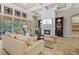 Bright living room with a fireplace, comfortable seating, and a view of the outdoor living area at 3543 Watermark Dr, Wesley Chapel, FL 33544
